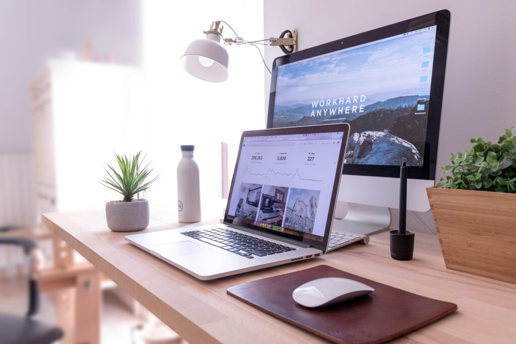 Computer and laptop on desk